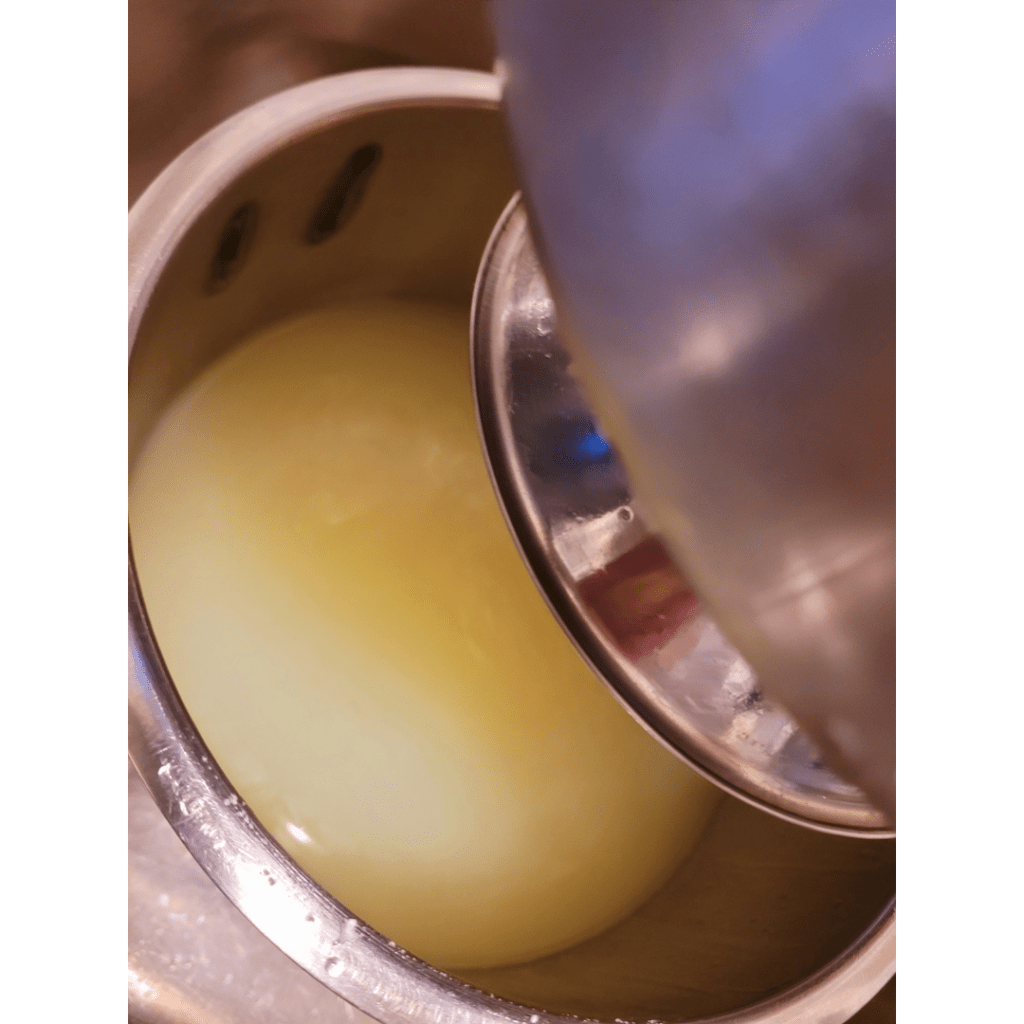 Image illustrates whey after draining curdled whole milk demonstrating a recipe for easy homemade ricotta cheese. 