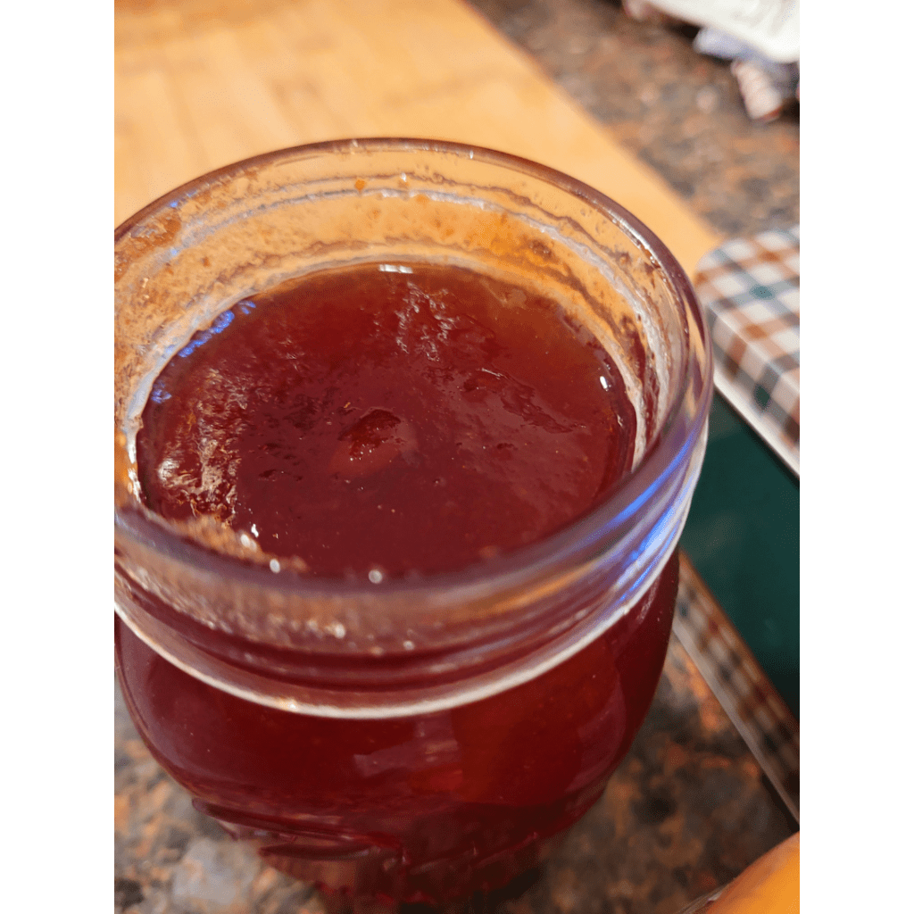 Image illustrates homemade jam in a mason jar.