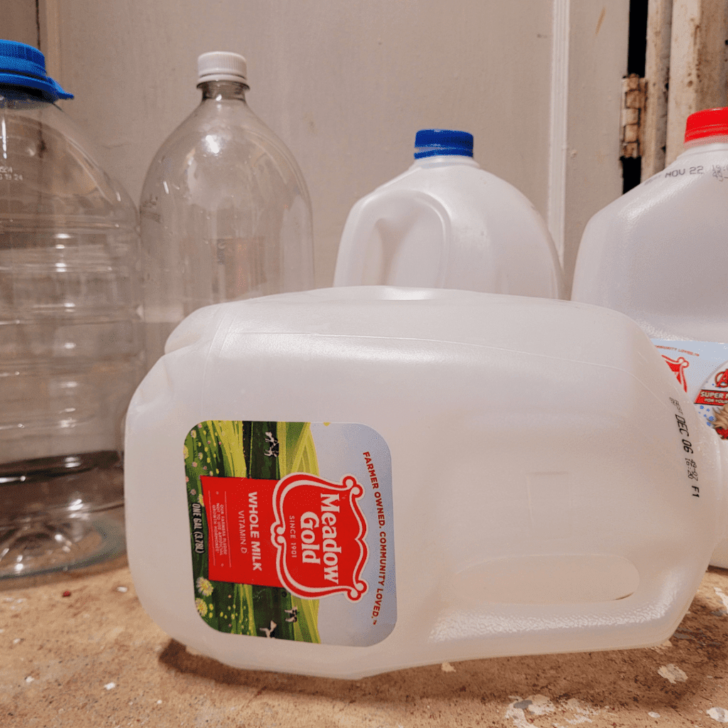 Image illustrates plastic containers for successful winter sowing for vegetables.