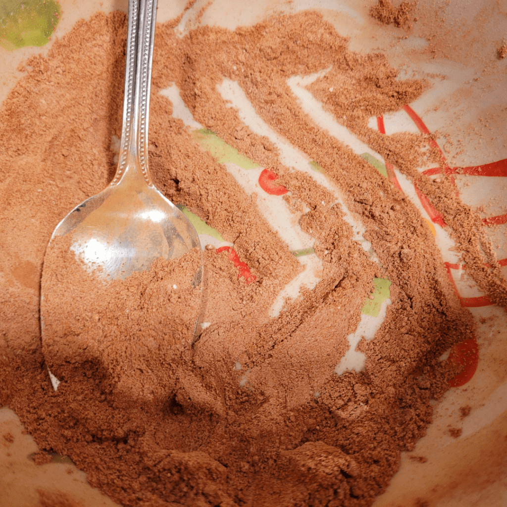 Image illustrates flour mixed with cocoa powder for a light dusting for a gingerbread cornucopia recipe. 