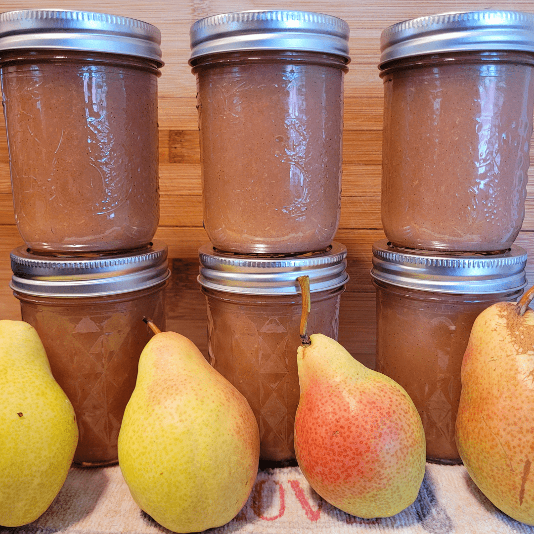 Image illustrates canned pear sauce and fresh pears demonstrating how to grow a productive canning garden.