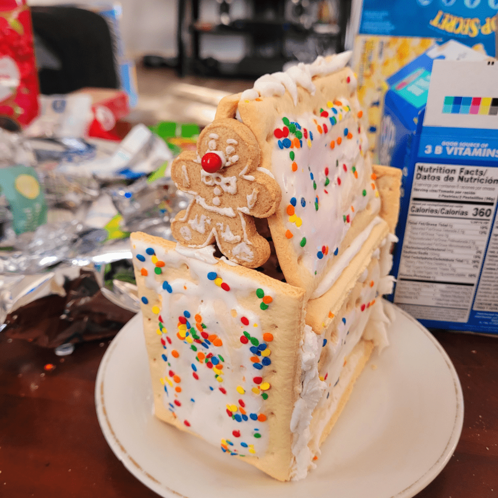 Image illustrates a Pop-Tart gingerbread house for a fun kids activity.
