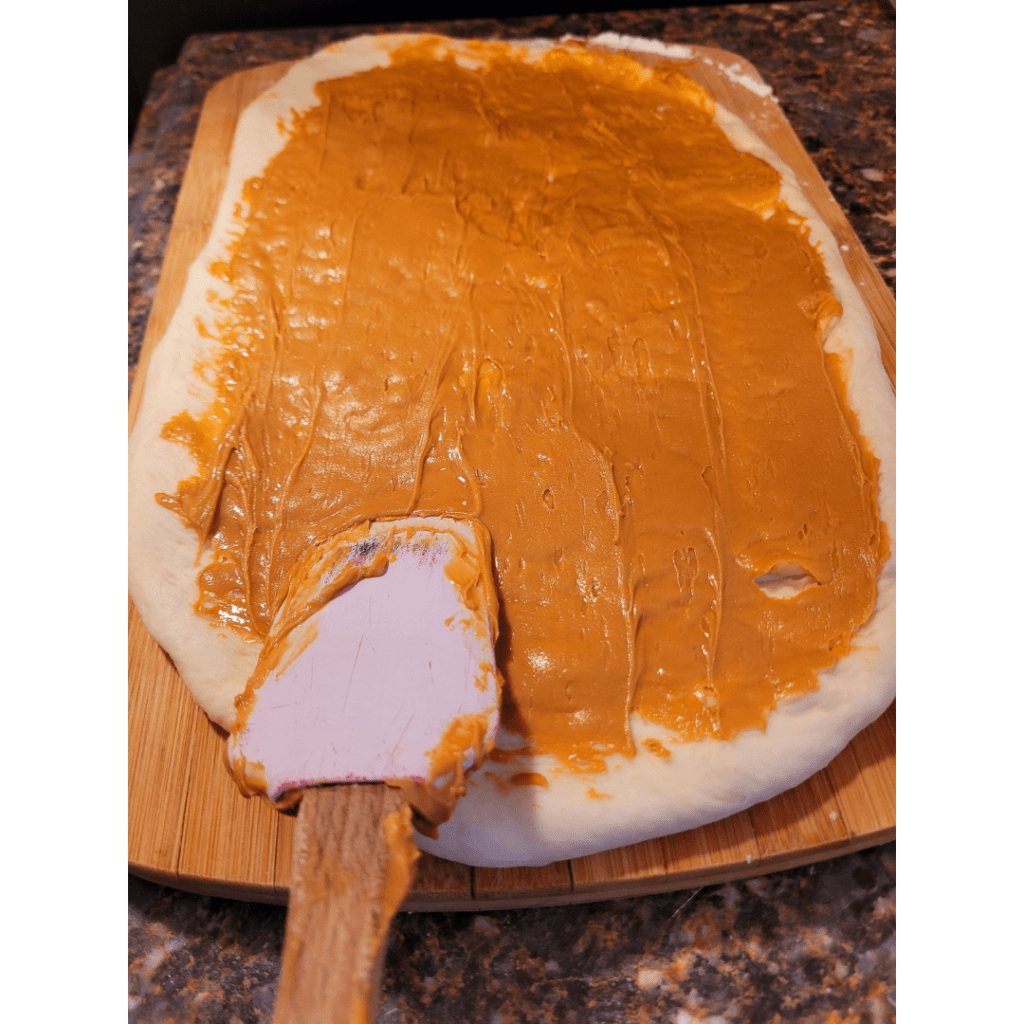 Image illustrates peanut butter spread on dough.