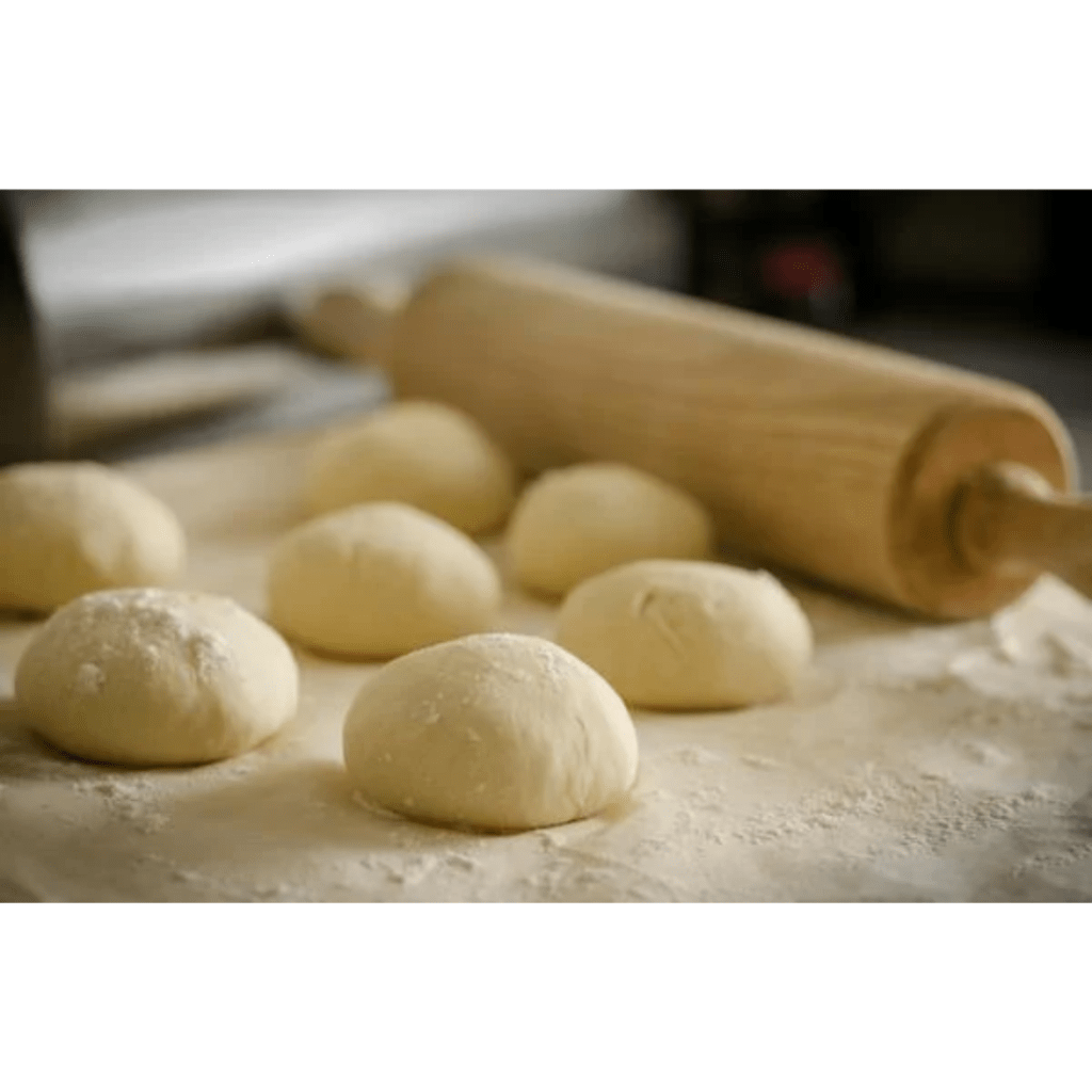 Image illustrates dough balls for a sourdough calzones recipe. 