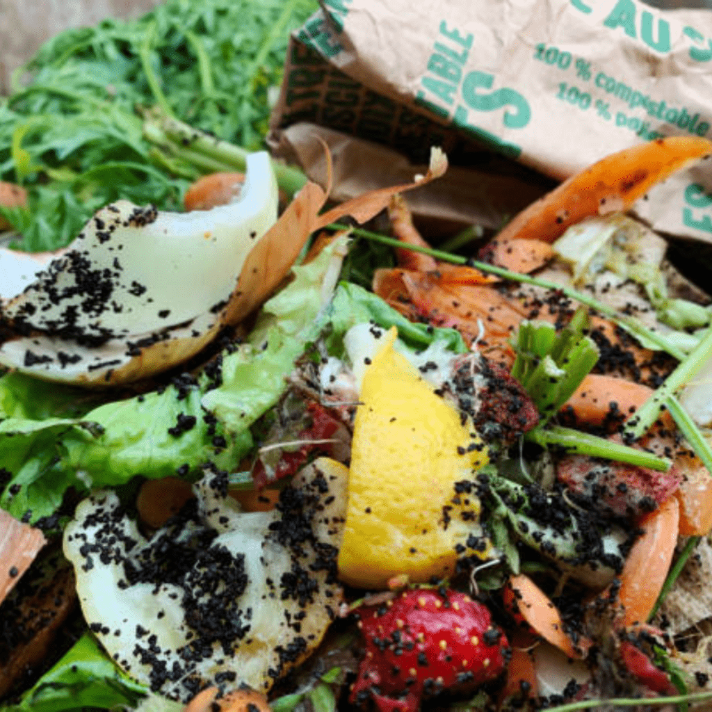 Image illustrates uses for coffee grounds in a compost bin.