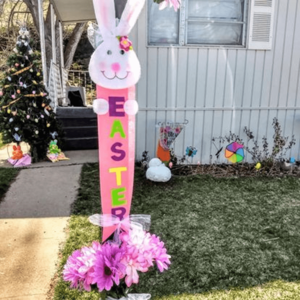 Image illustrates Easter decorations in the yard with a Christmas tree as an Easter tree. 