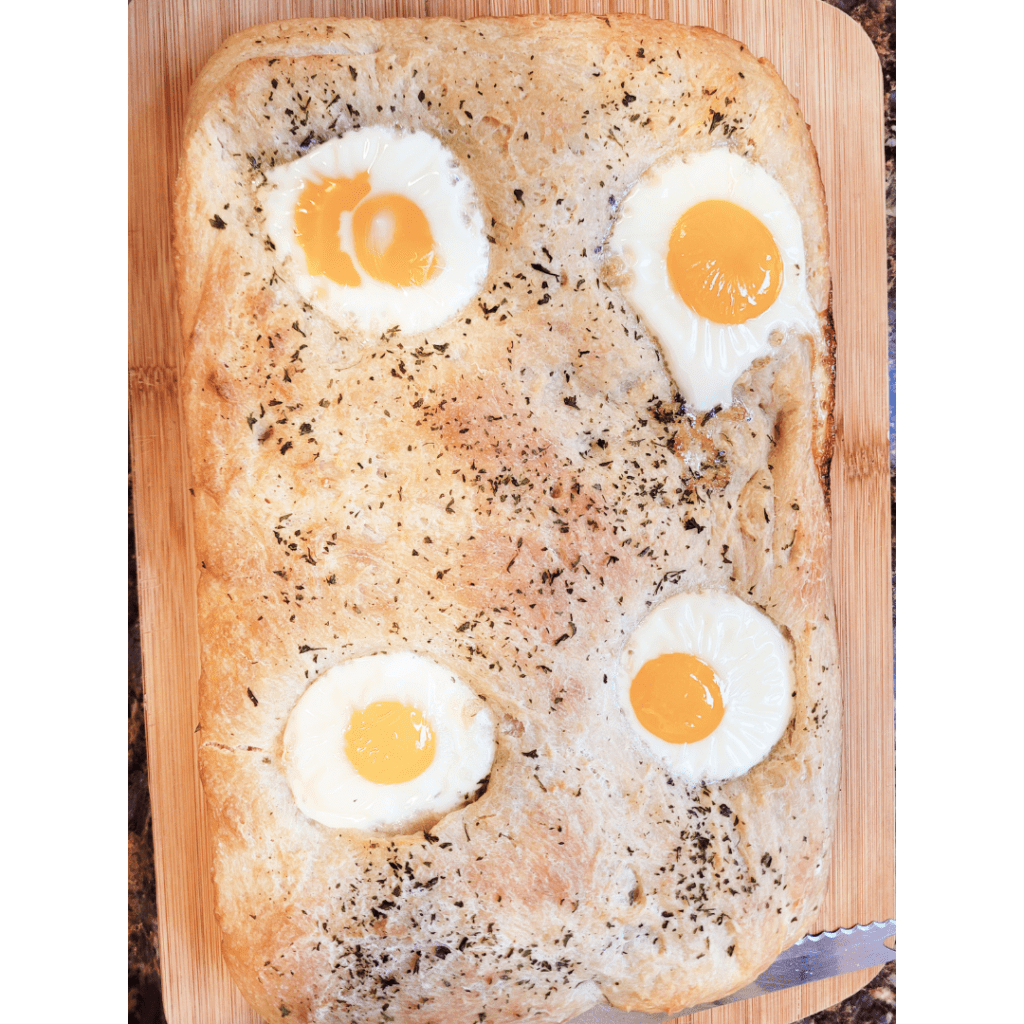 Image illustrates sourdough focaccia bread with eggs. 