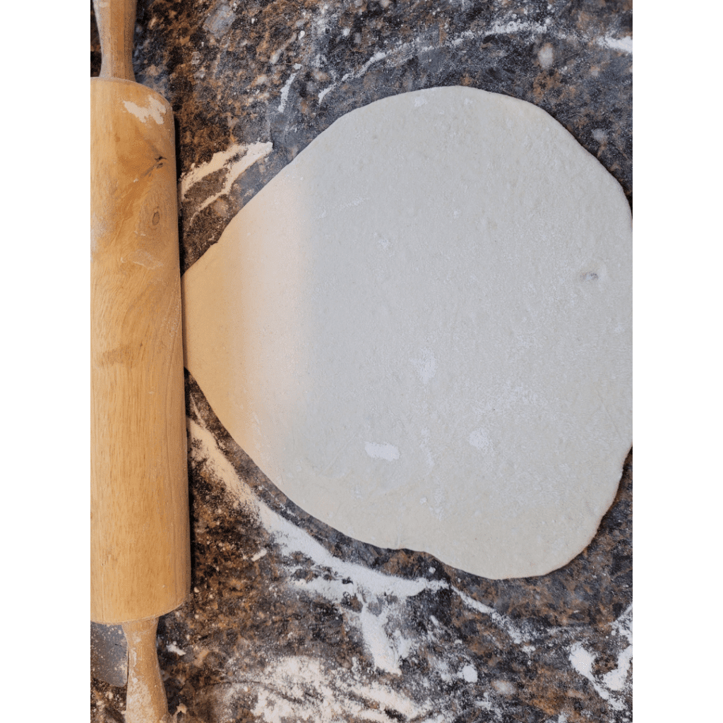 Image illustrates dough rolled out to make sourdough tortillas.