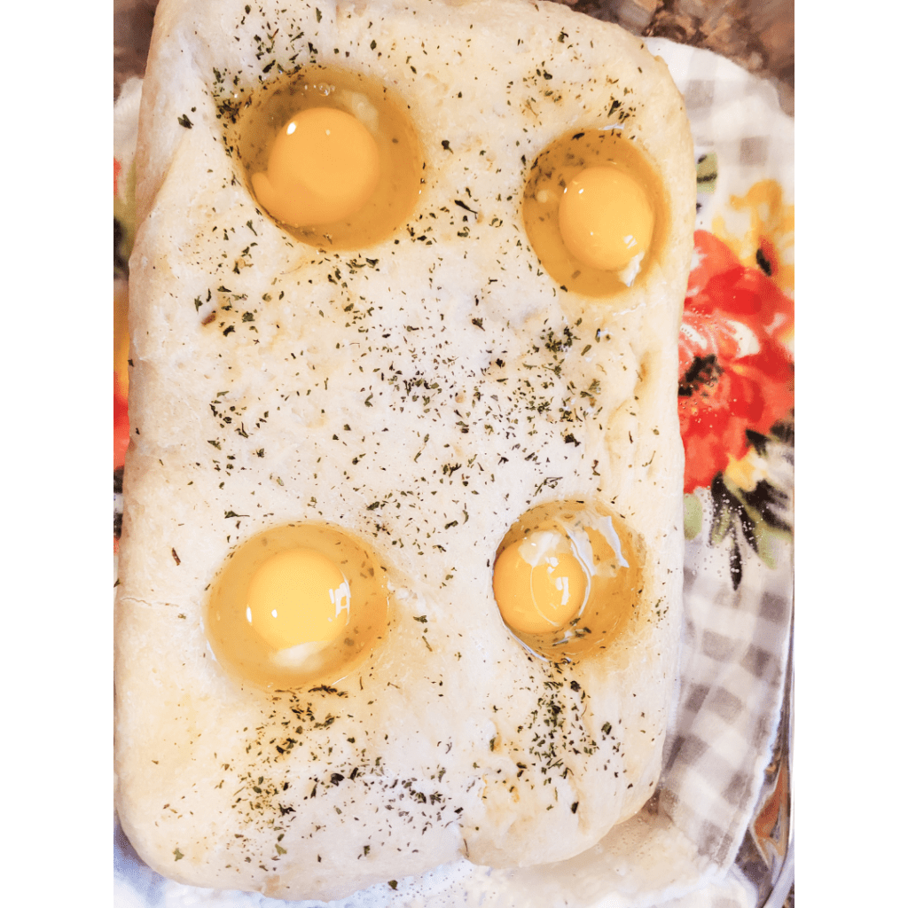 Image illustrates breakfast bread with baked eggs. 