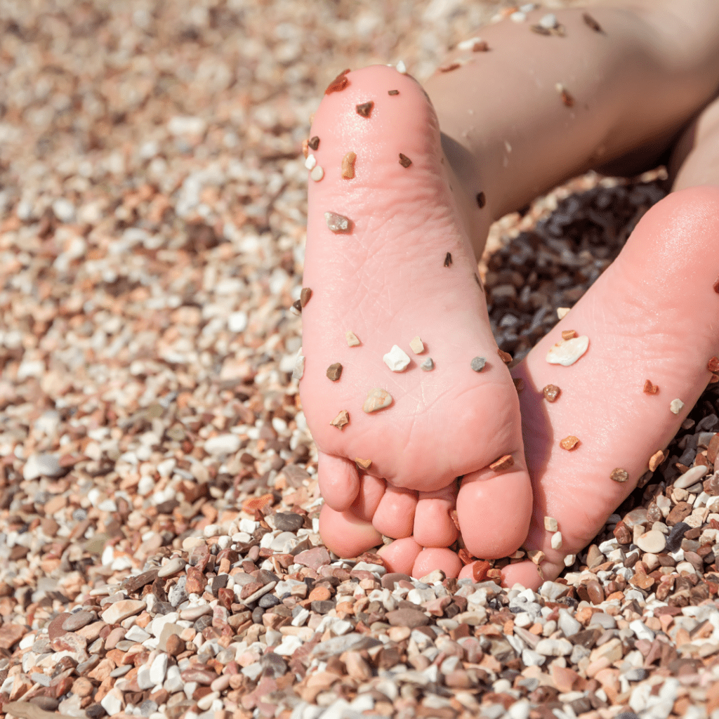 Image illustrates barefoot in pebbles for barefoot grounding.