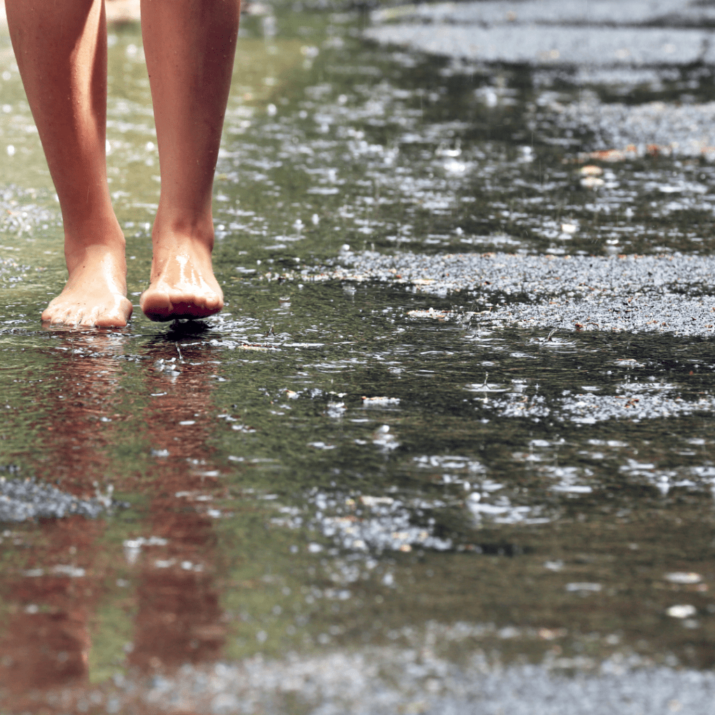 Image illustrates barefoot in water for barefoot grounding.