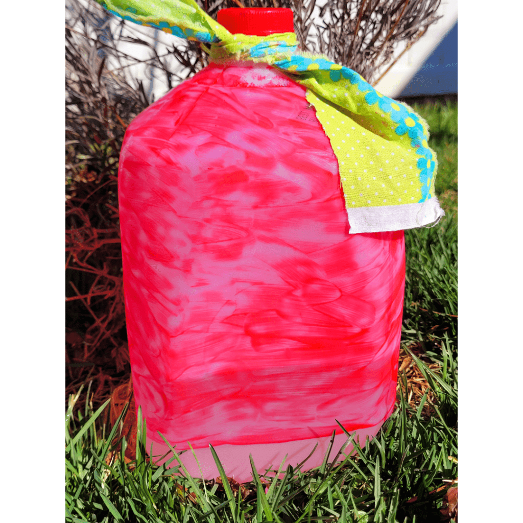 Image illustrates a milk jug drip irrigation system.