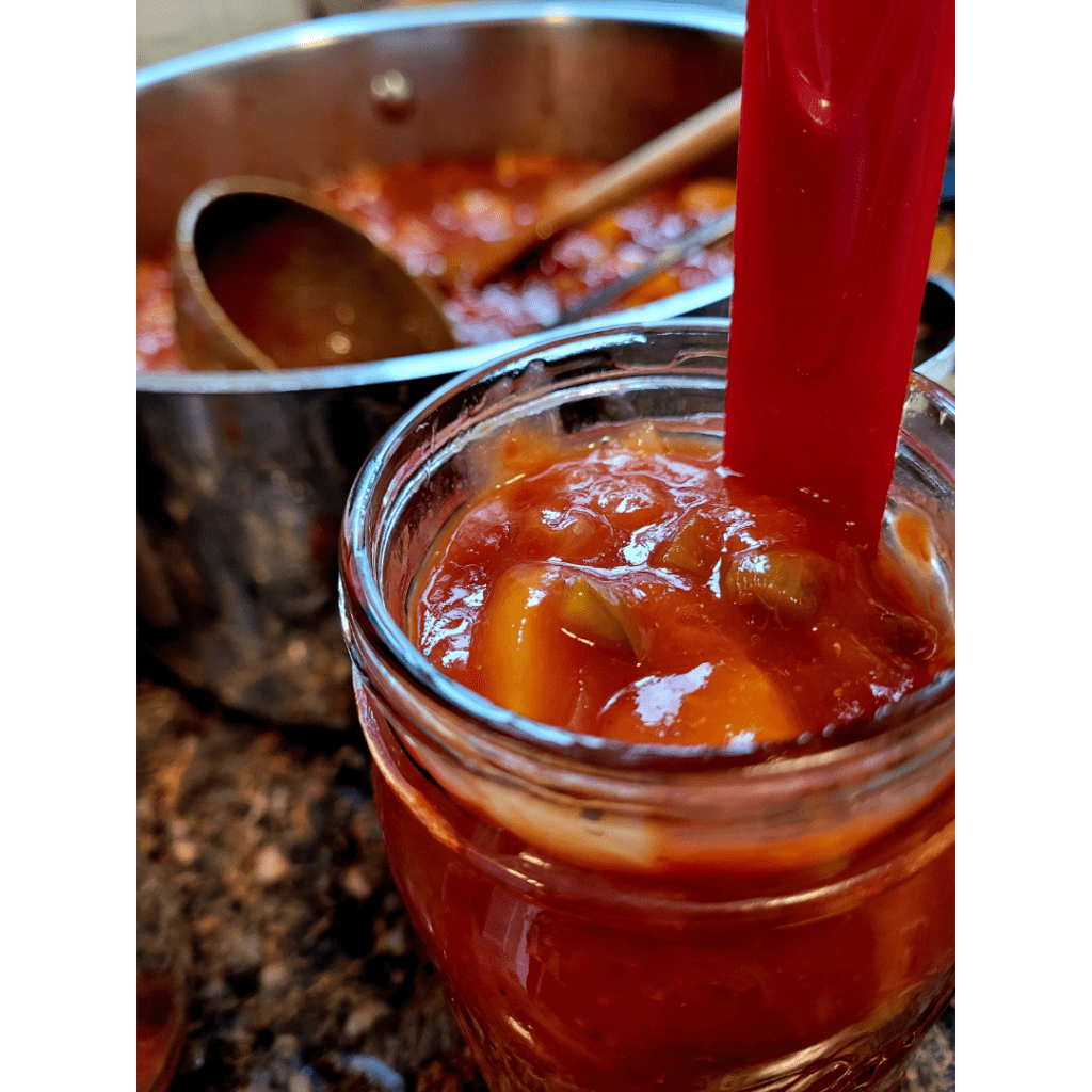 Image illustrates canning peach salsa. 