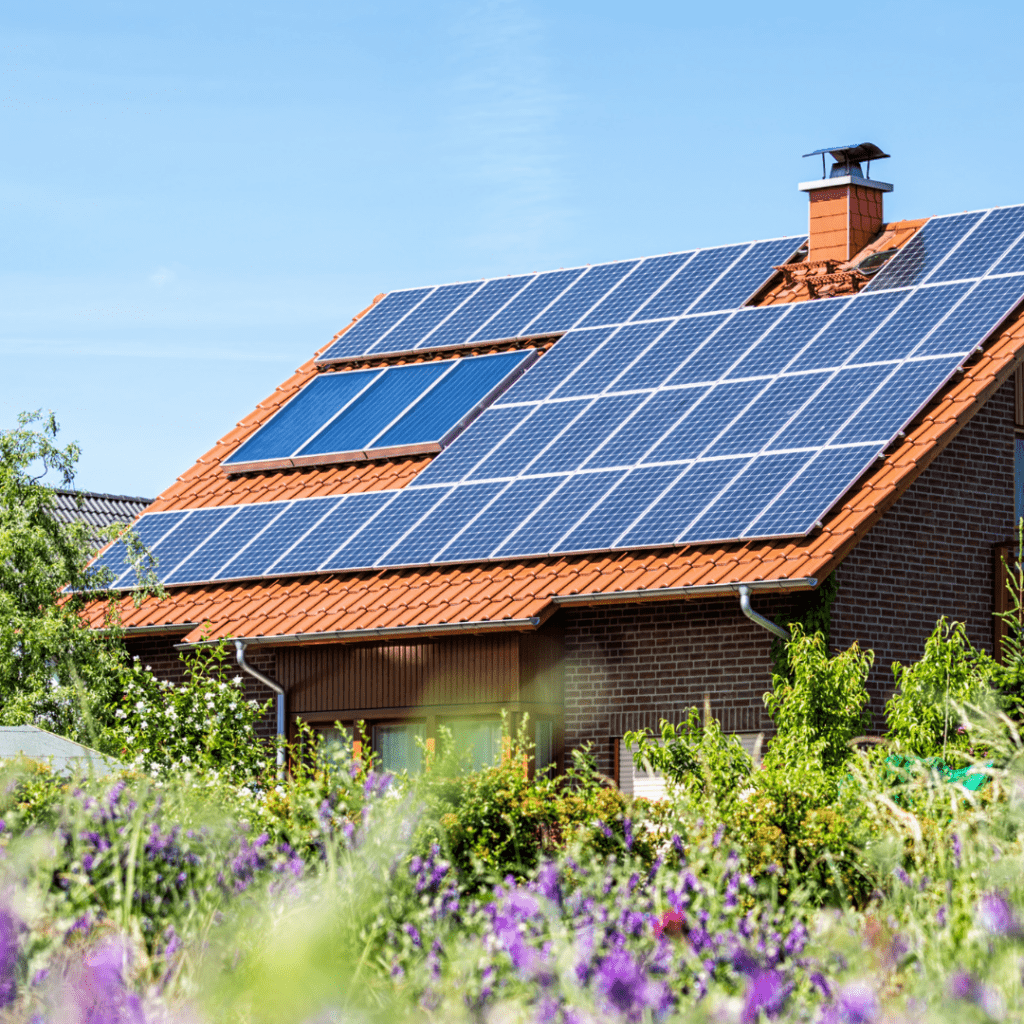 Image illustrates a house with solar panels for how to live off-grid. 