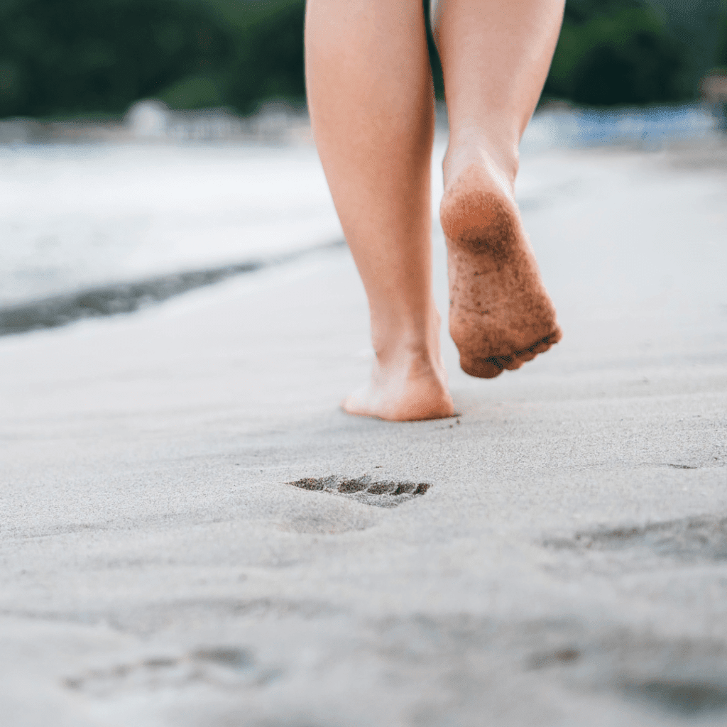 Image illustrates barefoot in the sand for barefoot grounding.