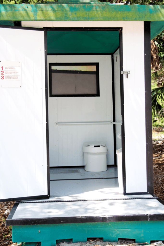 Image illustrates an outhouse with composting toilet systems.
