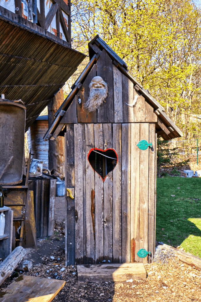 Image illustrates an outhouse with composting toilet systems.