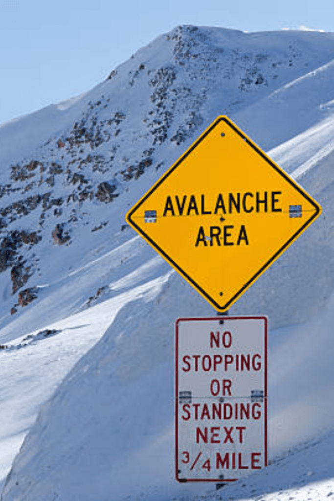 Image illustrates avalanche area signs demonstrating the importance of having avalanche gear.