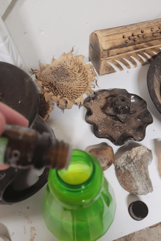 Image illustrates essential oils for plants being placed in a spray bottle.