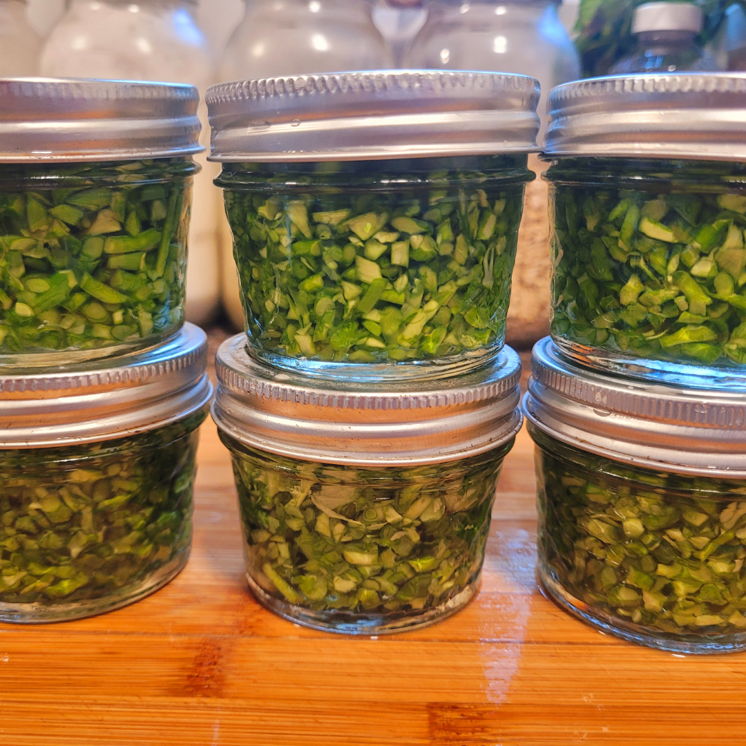 Image illustrates pickled garlic scapes.