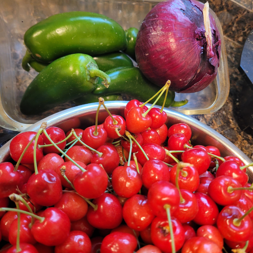Image illustrates cherries, jalapenos, and red onion.