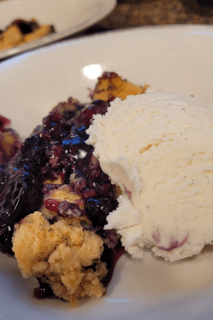Image illustrates blueberry cobbler. 
