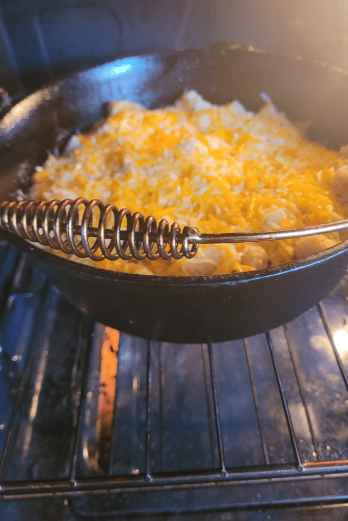 Image illustrates tater tot casserole in a Dutch oven. 