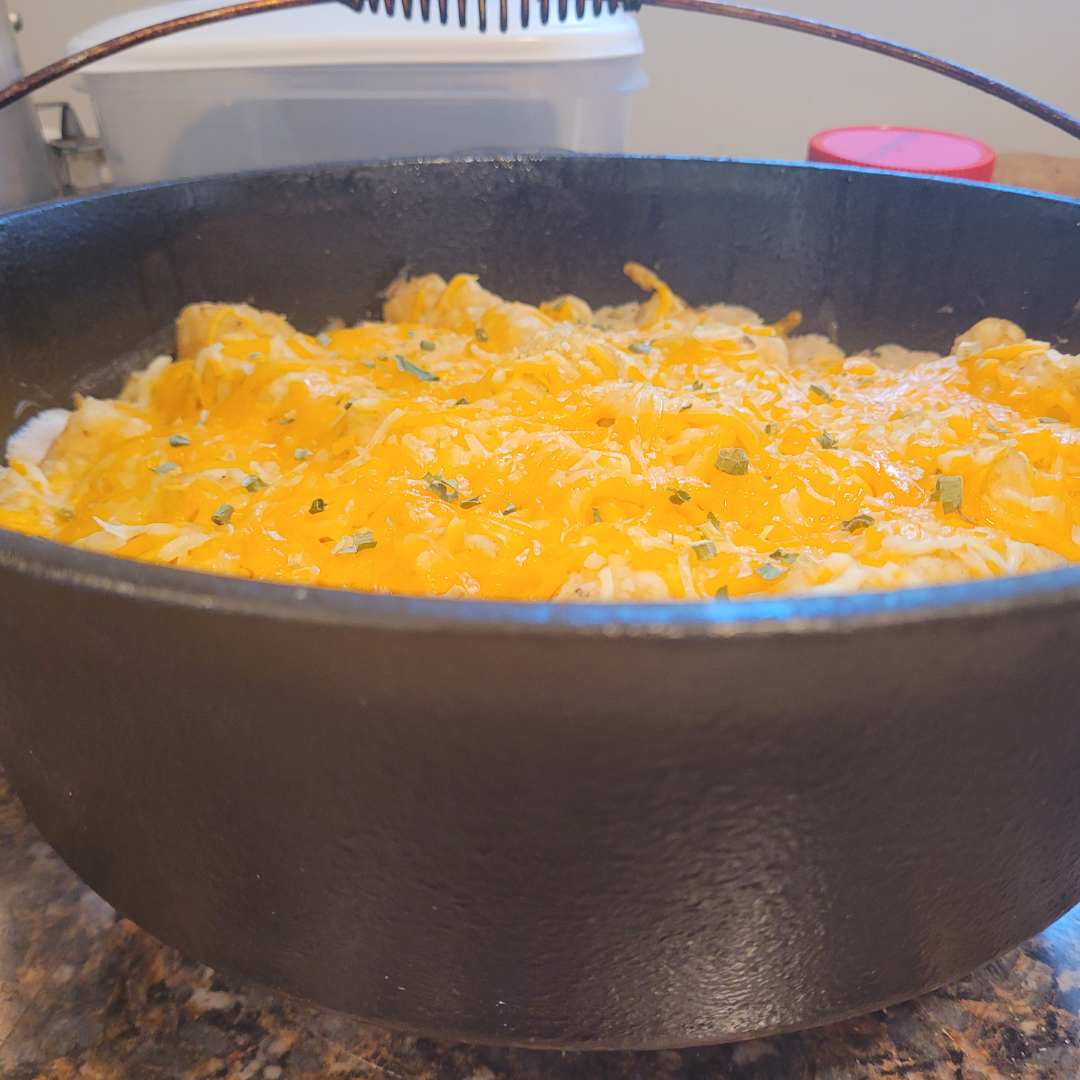 Image illustrates tater tot casserole in a Dutch oven.