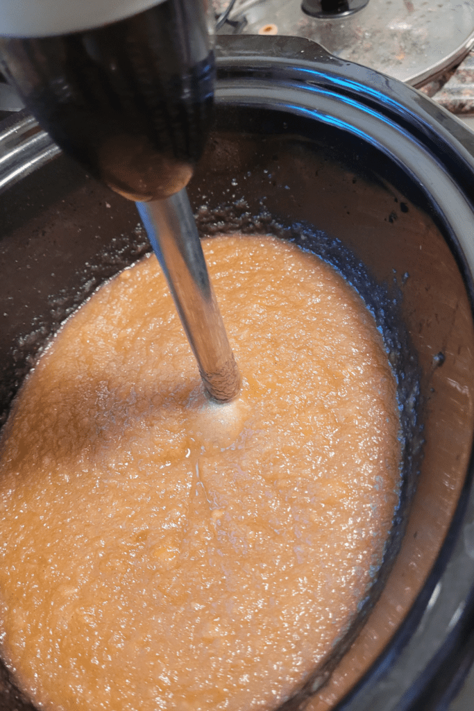 Image illustrates apple butter in crockpot.
