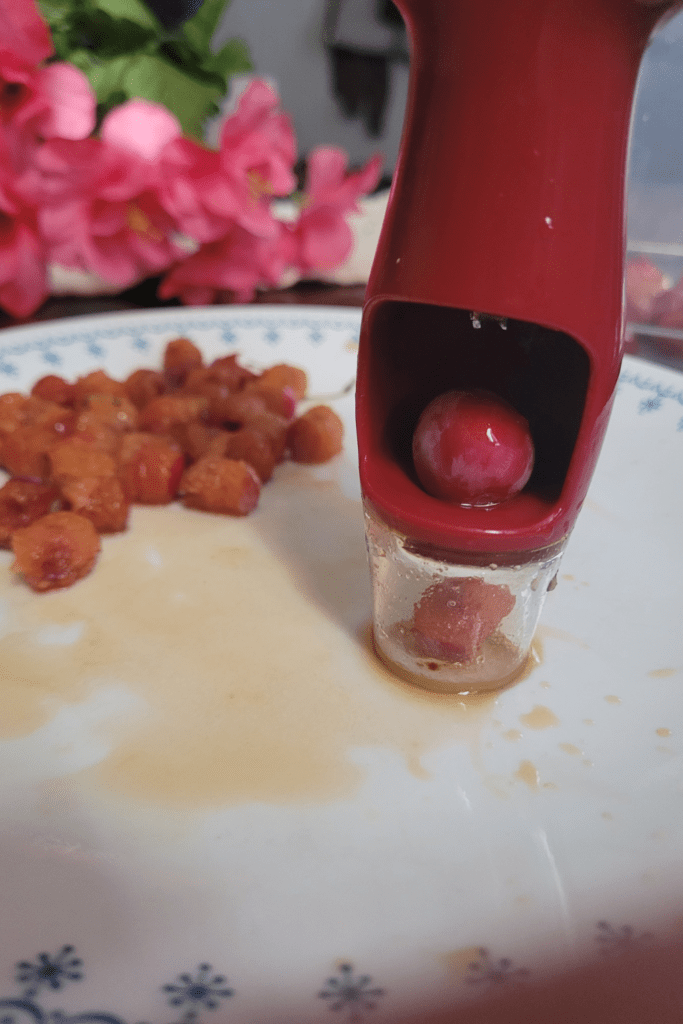 Image illustrates pitting cherry plums. 