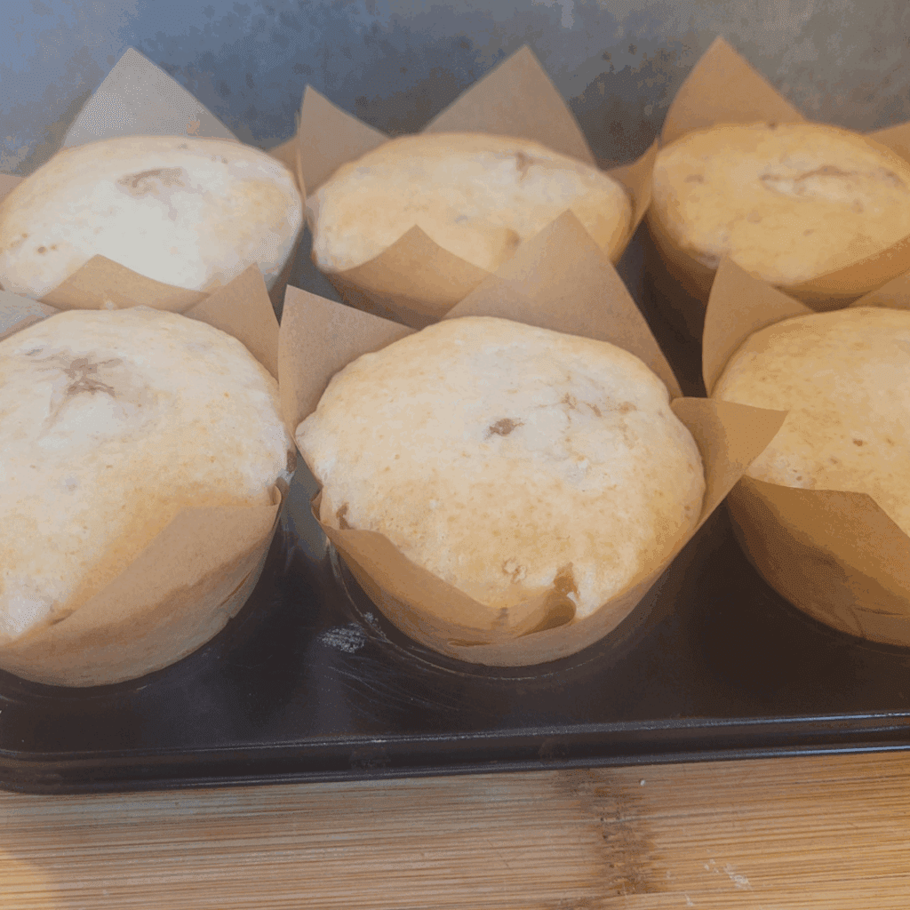 Image illustrates sourdough strawberry cheesecake muffins.