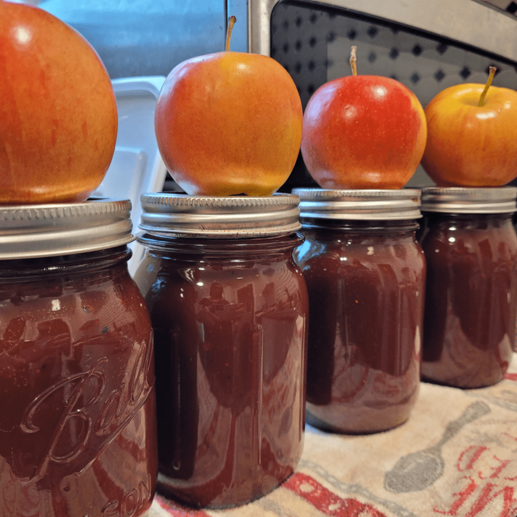 Image illustrates canning apple butter from The Off Grid Barefoot Girl.