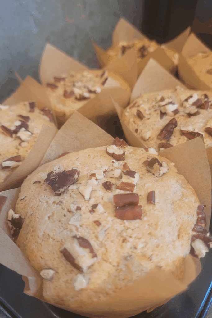 Image illustrates sourdough banana muffins.