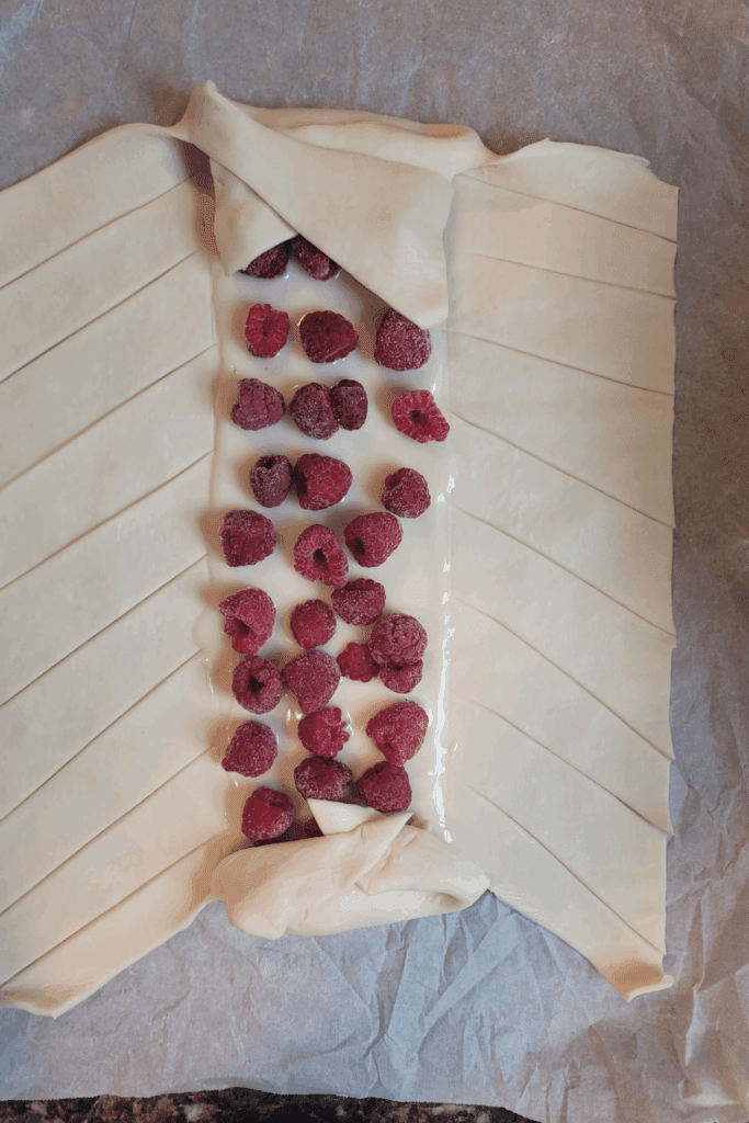 Image illustrates puff pastry raspberry and cream butter braid.