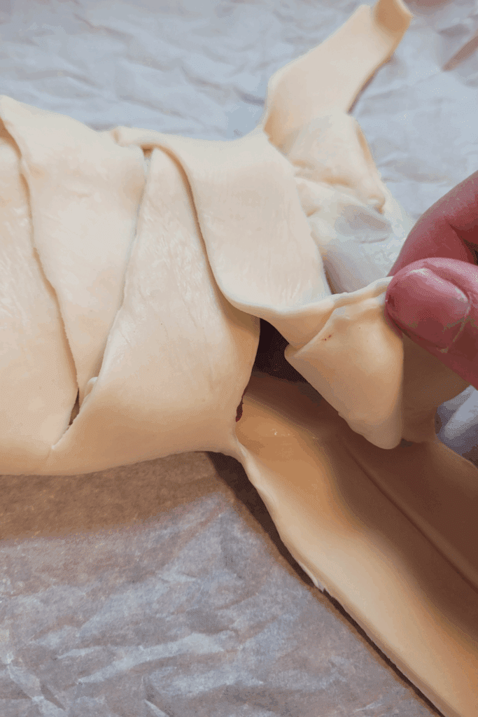 Image illustrates puff pastry raspberry and cream butter braid.