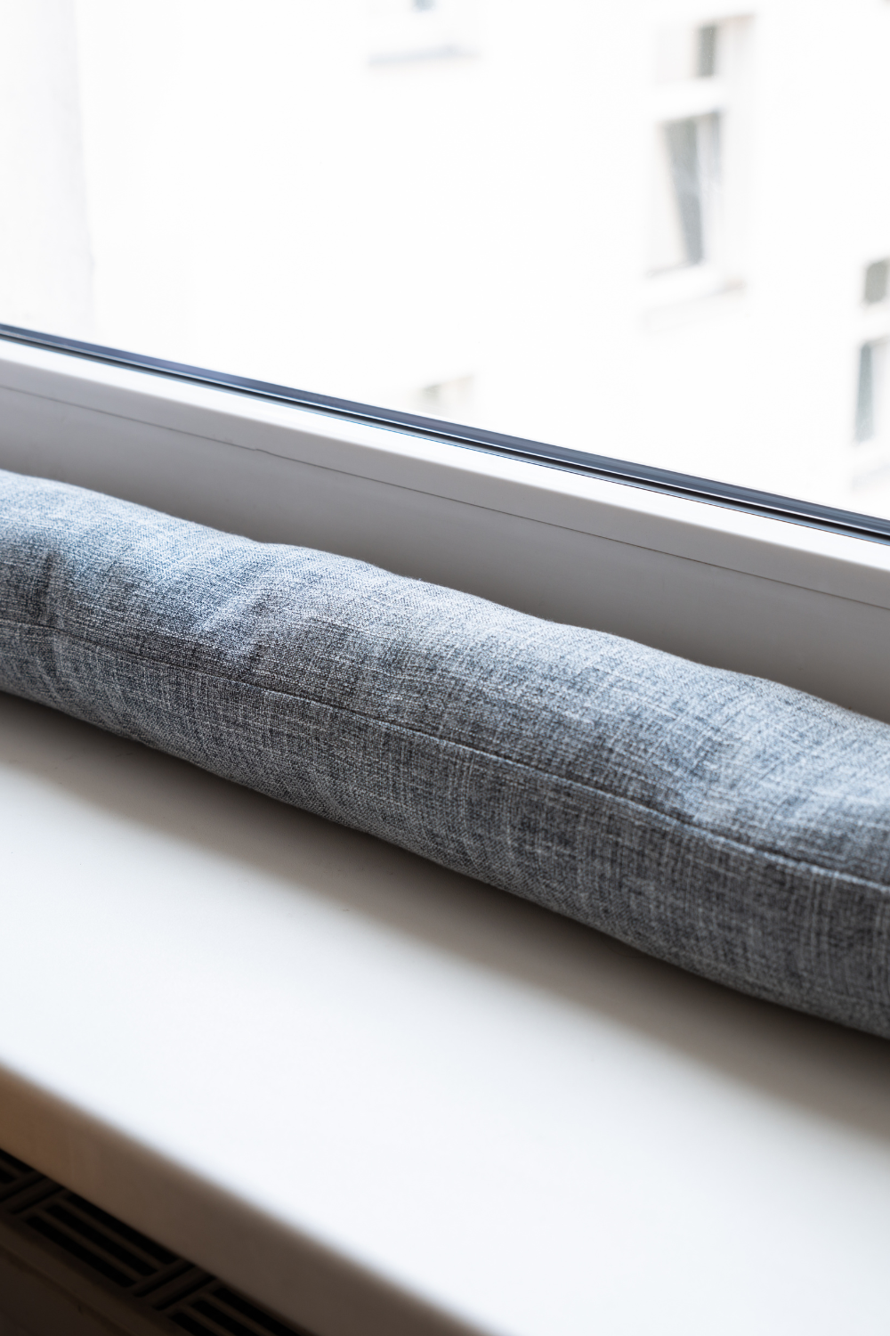 Image illustrates a draft stopper for how to prep your home for chilly fall nights.