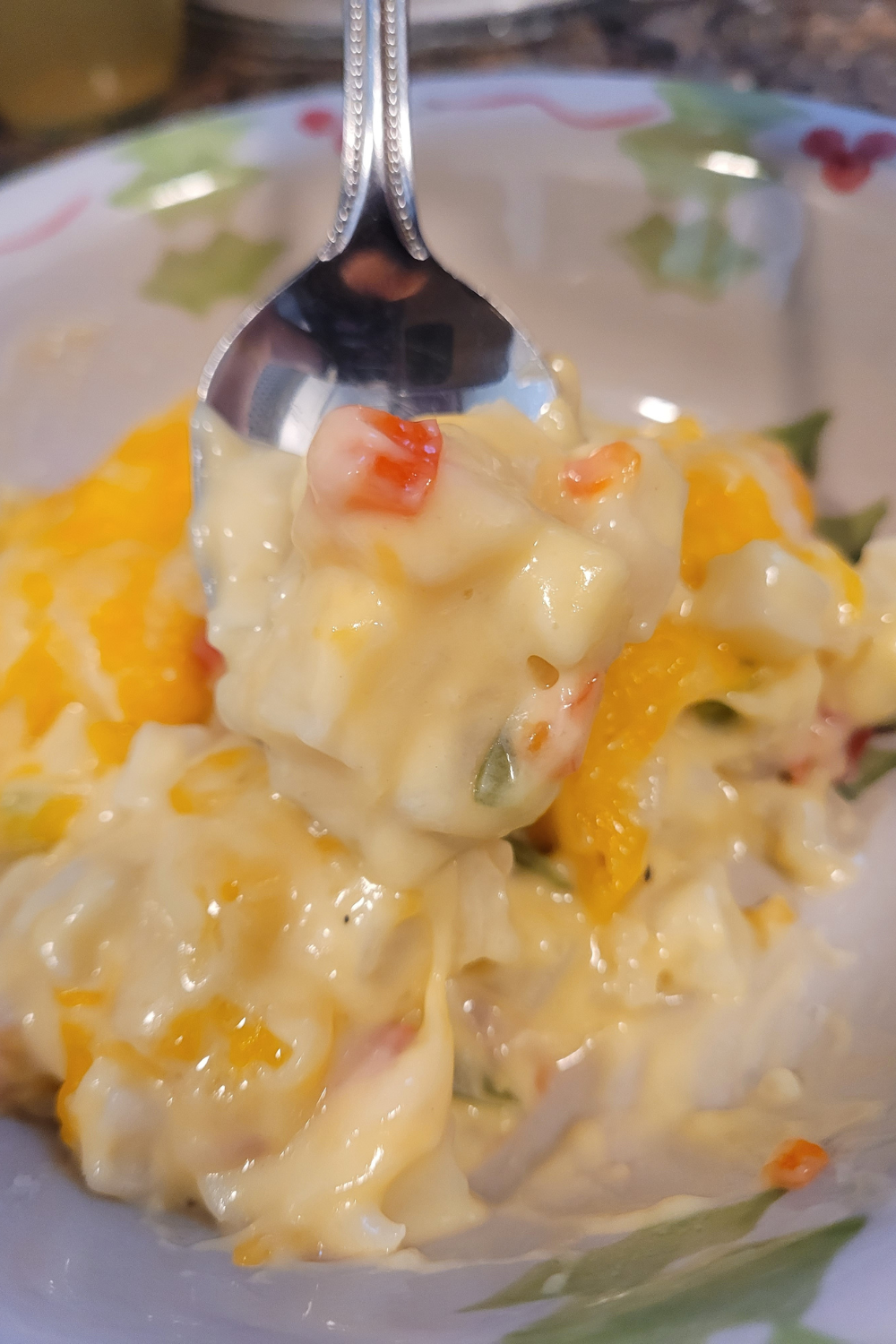 Image illustrates cheese potato casserole in a cast-iron skillet.