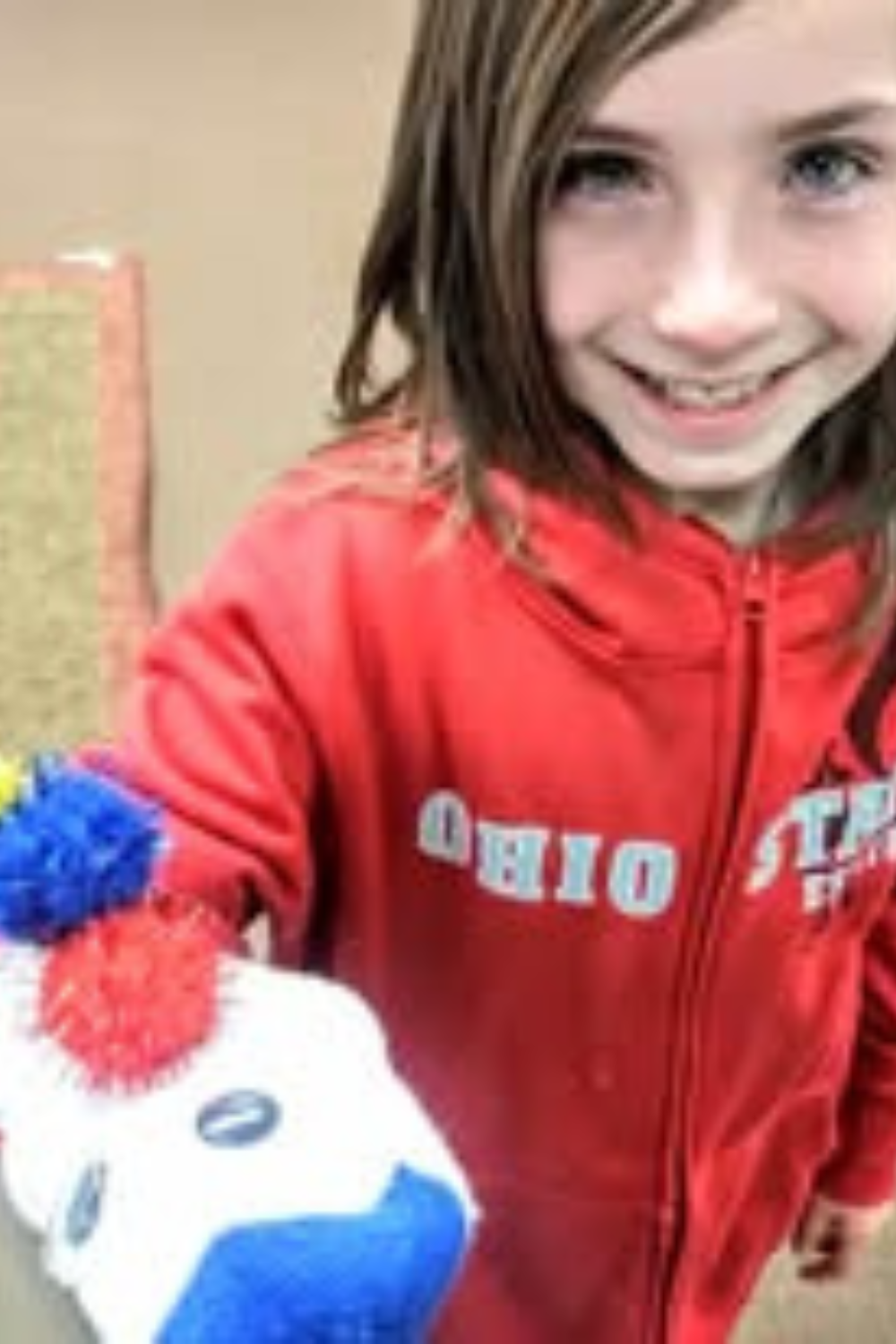 Image illustrates a kid with a sock puppet demonstrating how to make sock puppets.