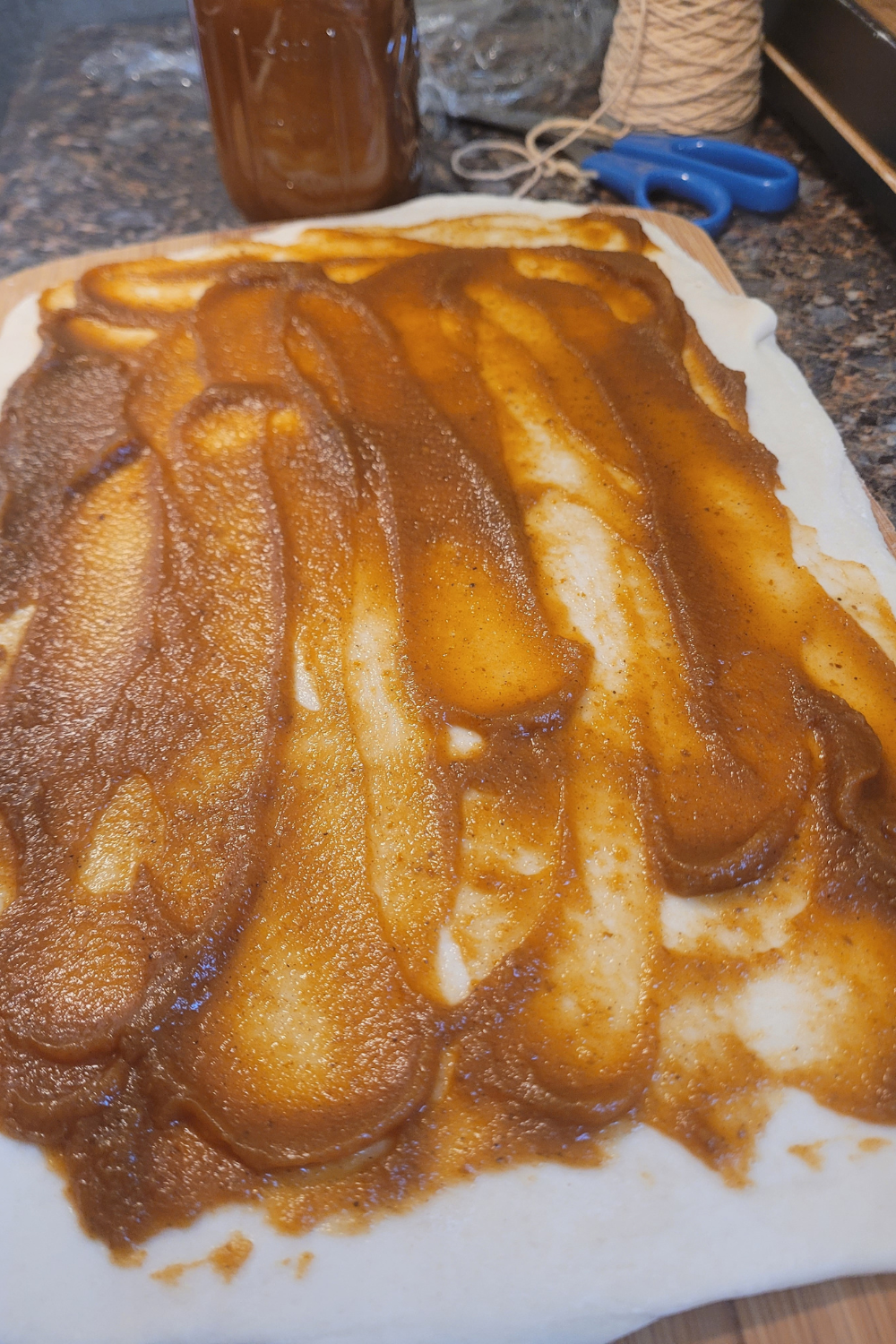 Image illustrates sourdough pumpkin shaped cinnamon rolls.