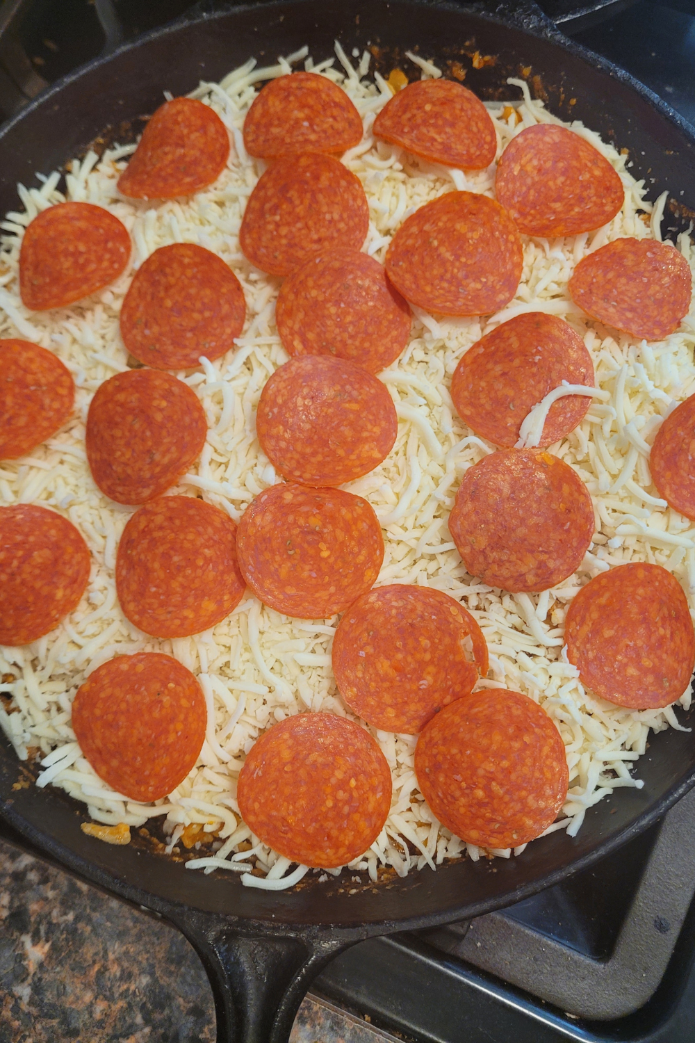 Image illustrates pizza casserole.