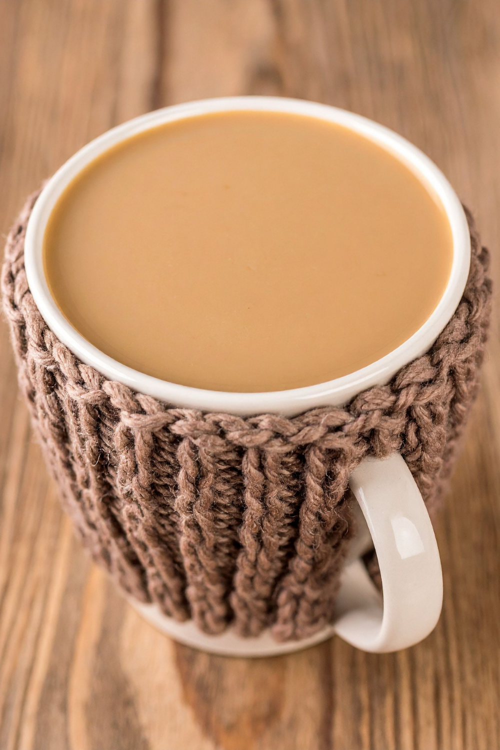 Image illustrates a knitted mug cozy for handmade Christmas gifts.