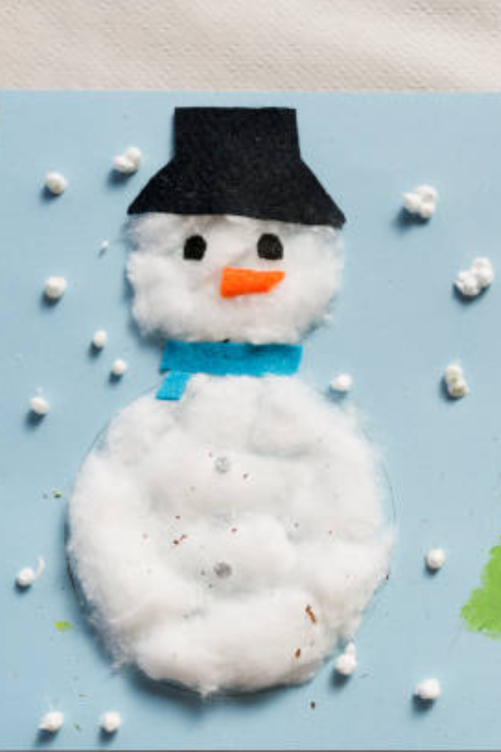 Image illustrates construction paper snowman and snowflake crafts  for easy Christmas crafts for kids.