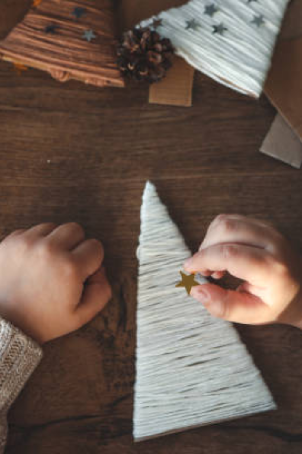 Image illustrates cardboard Christmas shapes and yarn crafts for easy Christmas crafts for kids.