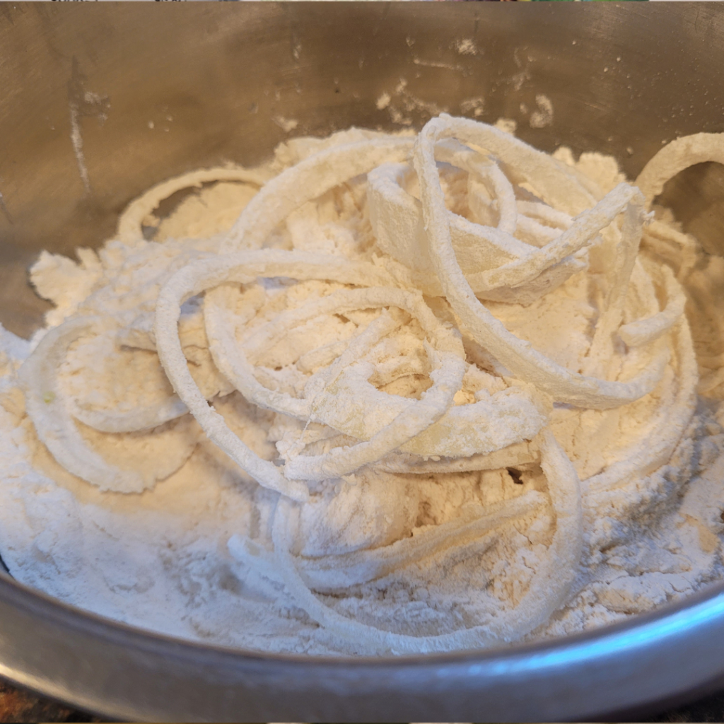 Image illustrates sliced onions for homemade fried onions.
