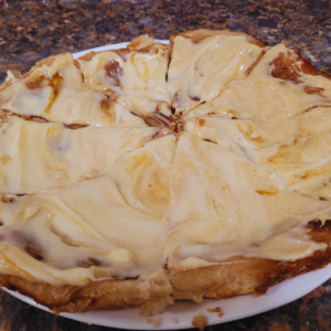 Image illustrates cinnamon roll pizza.