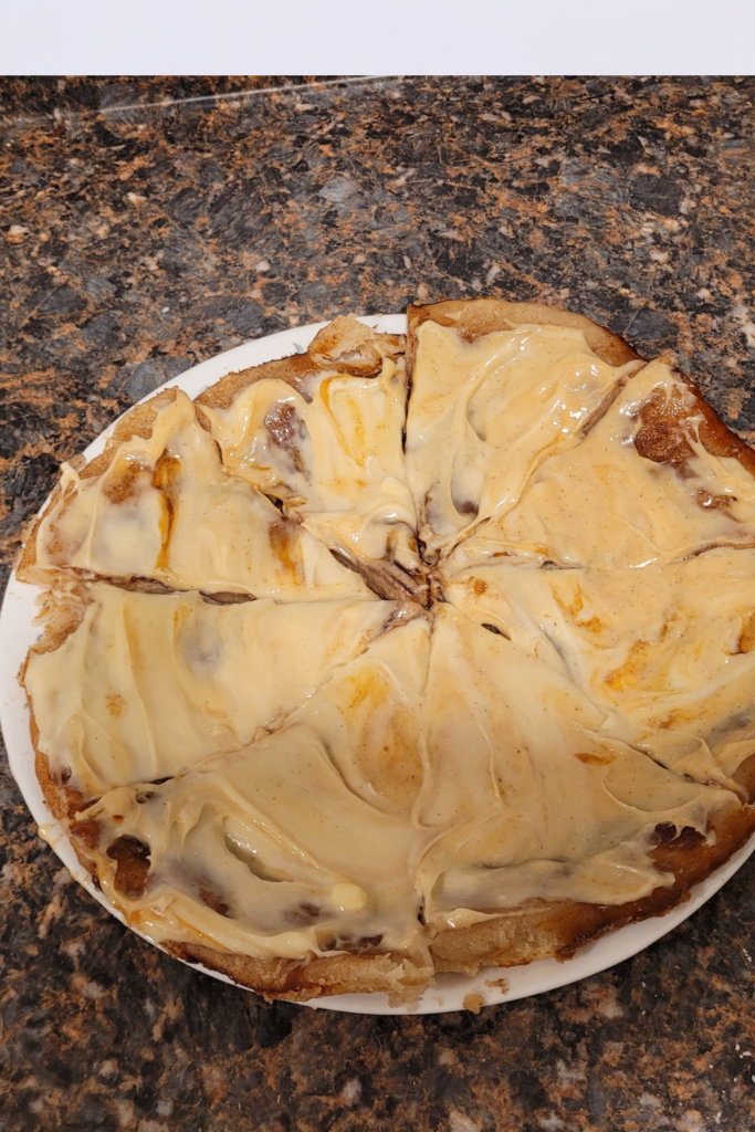 Image illustrates cinnamon roll pizza.