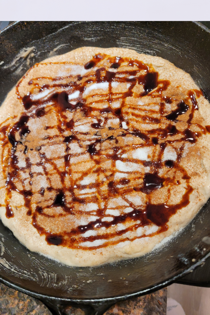 Image illustrates cinnamon roll pizza.